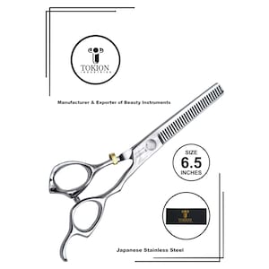May include: Silver-colored Tokion Industries hair thinning shears. The shears are 6.5 inches long. The text "Japanese Stainless Steel" is below the shears. The Tokion Industries logo is in a black circle.