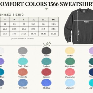 May include: A Comfort Colors 1566 sweatshirt size chart with a dark grey crewneck sweatshirt illustration. The chart displays width, length, and sleeve length in inches for sizes S to 3XL. Below, a color palette shows twenty labeled fabric swatches.