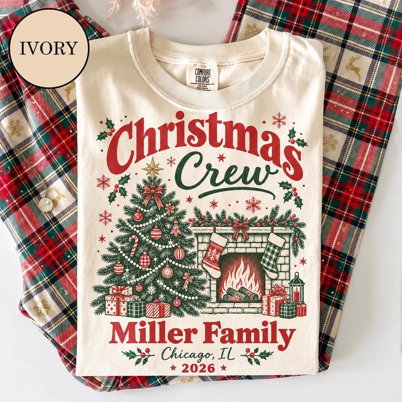 May include: An ivory t-shirt featuring a graphic of a Christmas tree, a fireplace with stockings, and gifts. The text reads: Christmas Crew, Miller Family, Chicago, IL, 2026. The design includes red and green accents, snowflakes, and holly leaves.