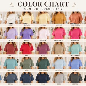May include: A color chart for Comfort Colors 1717 t-shirts, displaying a grid of 35 short-sleeve shirts in various solid colors. Each shirt is labeled with its specific color name, ranging from white, ivory, and yellow tones to pinks, reds, greens, blues, grays, and black.