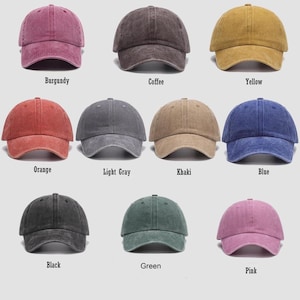 May include: A collection of ten baseball caps in various colors, including burgundy, coffee, yellow, orange, light gray, khaki, blue, black, green, and pink. Each cap has a curved brim and a fabric strap closure.