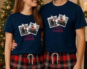 May include: Navy blue t-shirts with a photo print and the text "MERRY CHRISTMAS". The shirts feature a black and white photo of a couple. The models are wearing red and black plaid pajama pants.