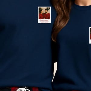 May include: Navy blue long-sleeve shirts with a small photo patch on the chest. The photo patch has a couple in red sweaters and the text "Happy Christmas" and "Love & Family".