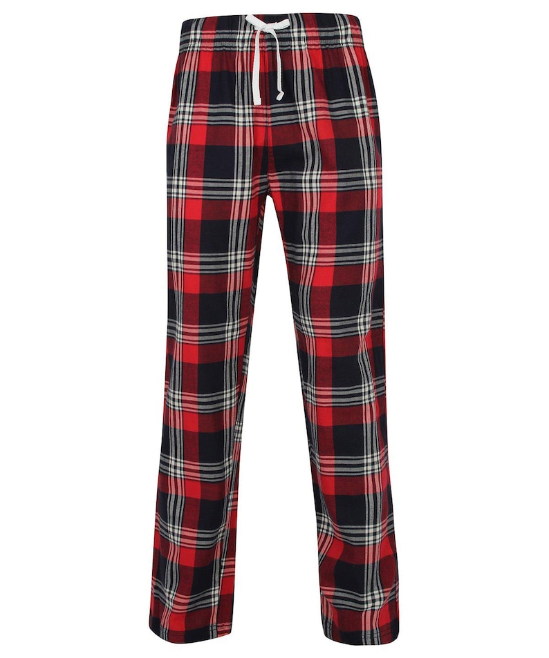 May include: Red and black plaid pajama pants with a white drawstring. The pants have a classic plaid pattern with a mix of red, black, and white lines. The pajama pants are made of a soft material.