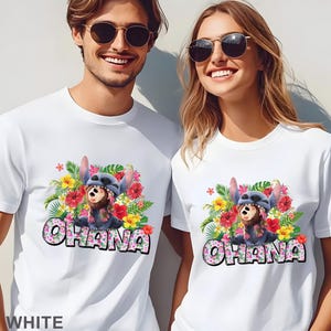 May include: White t-shirts featuring a colorful graphic of a cartoon character with floral accents and the word "OHANA". The design includes red, yellow, and green tropical flowers. The word "WHITE" is at the bottom.
