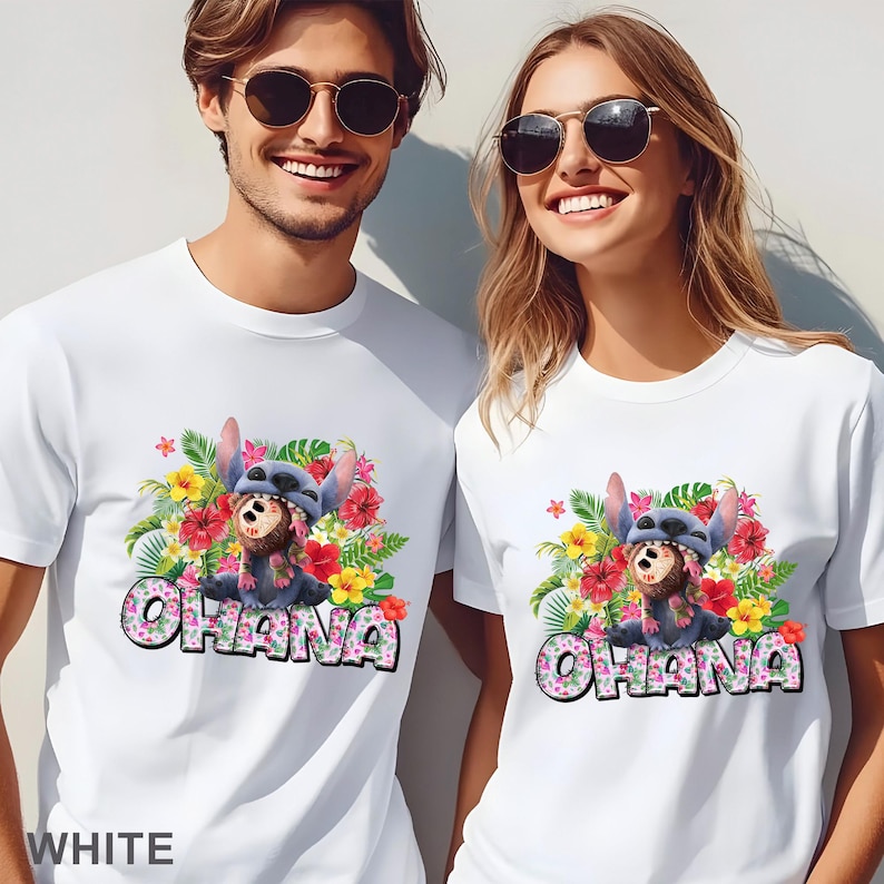 May include: White t-shirts featuring a colorful graphic of a cartoon character with floral accents and the word "OHANA". The design includes red, yellow, and green tropical flowers. The word "WHITE" is at the bottom.