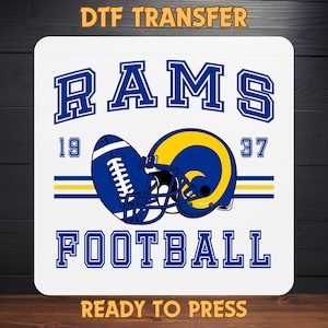 May include: A white square DTF transfer featuring a blue and yellow football helmet and football. The word "RAMS" is at the top, with "FOOTBALL" at the bottom. The numbers "19" and "37" are also present.