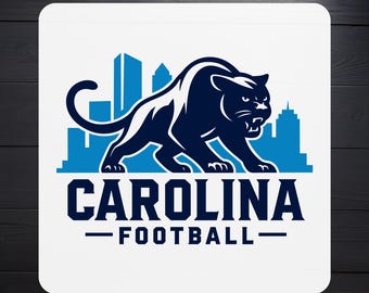 May include: A DTF transfer featuring a navy blue panther logo with a cityscape silhouette in light blue. The text "CAROLINA FOOTBALL" is displayed below the panther. The words "DTF TRANSFER" and "READY TO PRESS" are also present.