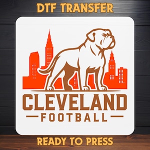 May include: A white DTF transfer featuring a brown bulldog silhouette in front of an orange cityscape. The words "CLEVELAND FOOTBALL" are below the dog, with "DTF TRANSFER" and "READY TO PRESS" at the top and bottom.