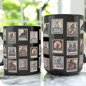 May include: Two black ceramic mugs with a collection of vintage-style postage stamps featuring illustrations of aliens, Bigfoot, and other cryptids. The stamps are arranged around the mugs, with the text "SPACE NEEDED" on some.