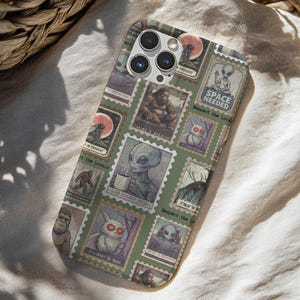 May include: A phone case featuring a collage of vintage-style postage stamps with extraterrestrial and cryptid illustrations. The stamps include images of aliens, Bigfoot, and other mysterious creatures, with phrases like "SPACE NEEDED" and "Respect the Locals."