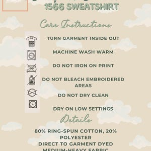 Beige cloud-themed care instruction card for Comfort Colors 1566 sweatshirt with icons showing washing, drying, and care symbols, plus text detailing washing instructions and material information.