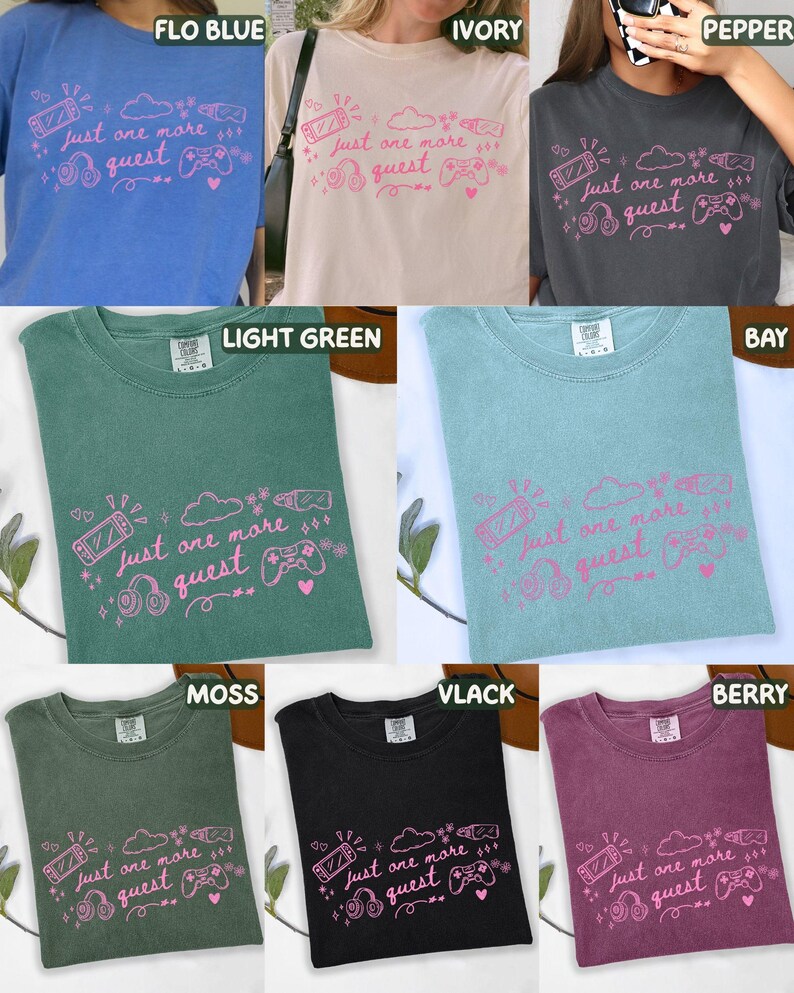 May include: A selection of t-shirts in shades such as blue, cream, and green. Each shirt displays the pink phrase "Just one more quest" alongside gaming-themed illustrations, including a games console and headphones. The shirts are made of a soft fabric.