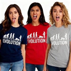 May include: Three t-shirts in navy, red, and grey, each with a white graphic depicting human evolution and the word "EVOLUTION". The short-sleeved shirts are worn by three people.