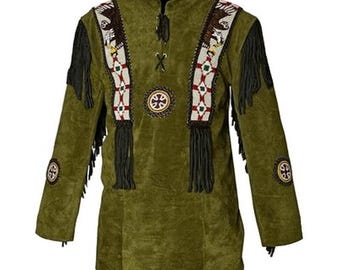 May include: Olive green suede shirt with long sleeves and a mandarin collar. The shirt features decorative beadwork with eagle motifs, fringe, and circular embroidered patches. The design incorporates red, white, and black accents.