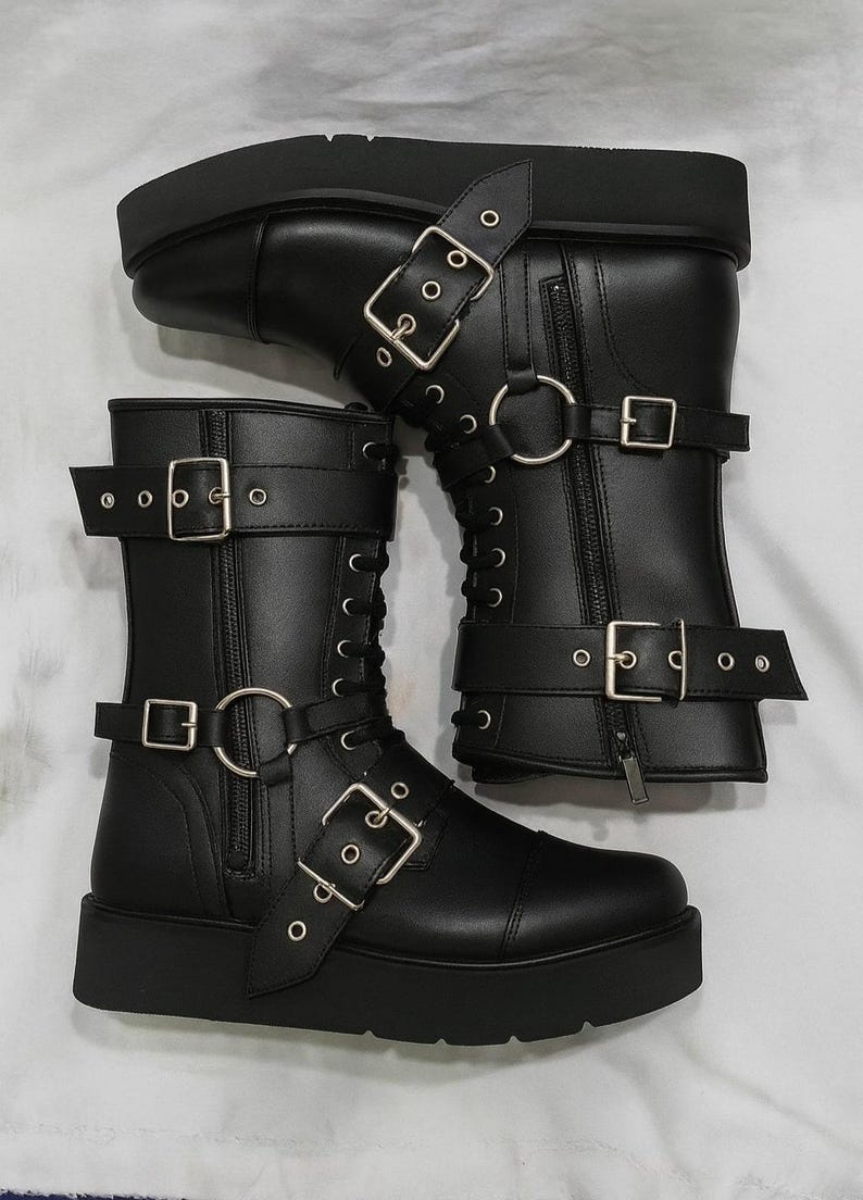 Handmade black leather wrestling boots designed for pro wrestlers and performers. These durable wrestling shoes feature lace-up closure, side zipper, and multiple buckle straps for a secure fit and bold style. Perfect for wrestling matches, cosplay, costumes, and stage performances. Crafted from premium quality leather for long-lasting wear, comfort, and stability in the ring. Unisex wrestling boots available in custom sizes for men and women.