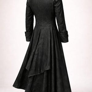 May include: A long, black coat with a flared skirt and a tailored fit. The coat features a notched collar, long sleeves with buttoned cuffs, and a back vent. The fabric appears to be leather or a leather-like material.