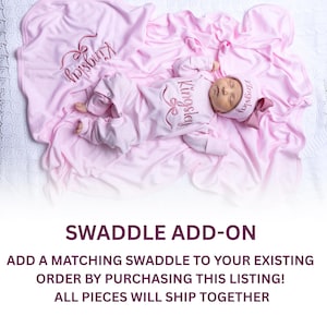 May include: A newborn baby wearing a pink onesie, hat, and swaddle blanket. The name "Kingsley" is embroidered in a darker pink on the outfit and blanket. The text "SWADDLE ADD-ON" is at the bottom of the image.
