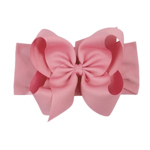 May include: A pink fabric headband with a large pink bow.