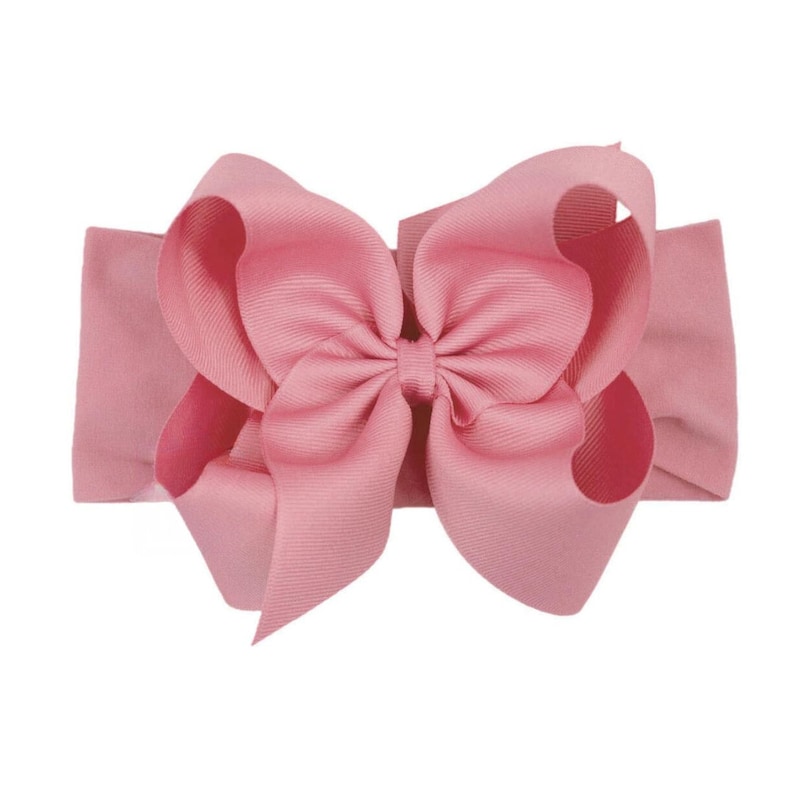 May include: A pink fabric headband with a large pink bow.