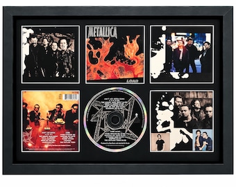 May include: A framed Metallica Load album display featuring the original cover art, a central compact disc with track listings, and four additional panels showcasing band photography and album details in a black mat and black frame.
