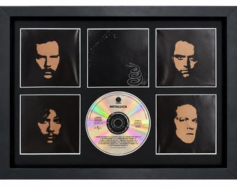 May include: A framed display featuring a Metallica CD in the centre, surrounded by five square panels. Four panels show high-contrast portraits of band members, while the top centre panel displays the iconic snake logo from the Black Album.
