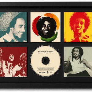 May include: Framed Bob Marley & The Wailers album art print. The print features six images of Bob Marley, including a CD of "Africa Unite: The Singles Collection." The frame is black.