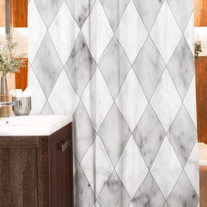 May include: A white and gray marble-patterned shower curtain with a diamond design. The curtain hangs from a white rod and features a repeating pattern of gray diamonds on a white background. The bathroom setting includes a dark wood vanity.