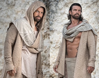 May include: Two men wearing beige hooded cardigans with a textured pattern. One man is wearing a white t-shirt underneath his cardigan and the other man is wearing a brown leather belt and a brown scarf.