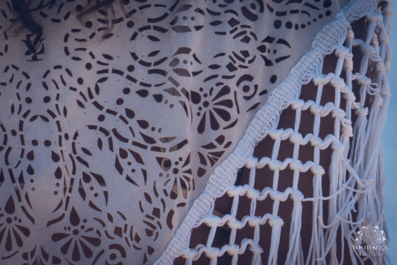 May include: White crochet shawl with a delicate floral pattern and fringe trim. The shawl is made of a lightweight, breathable fabric and is perfect for layering.