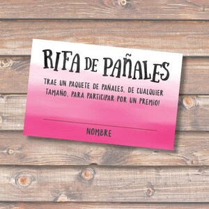 May include: Pink and white raffle ticket with the text "RIFA DE PAÑALES" in black. The text below reads "TRAE UN PAQUETE DE PAÑALES, DE CUALQUIER TAMAÑO, PARA PARTICIPAR POR UN PREMIO!" and "NOMBRE" at the bottom.