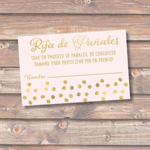 May include: Pink and gold raffle ticket with the text "Rifa de Pañales" and "TRAE UN PAQUETE DE PAÑALES, DE CUALQUIER TAMAÑO, PARA PARTICIPAR POR UN PREMIO!" and a line for a name.
