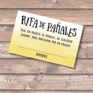 May include: A yellow and white raffle ticket with the text "RIFA DE PAÑALES" in black. The text below reads "TRAE UN PAQUETE DE PAÑALES, DE CUALQUIER TAMAÑO, PARA PARTICIPAR POR UN PREMIO!" and "NOMBRE" at the bottom.