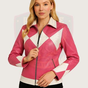 May include: A pink leather jacket with white diamond-shaped panels and a zipper closure. The jacket has a white collar and white cuffs.