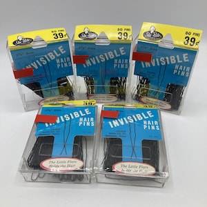 May include: Six packages of black hair pins. Each package contains 80 pins and is labeled "Sta-Rite Invisible Hair Pins". The packages are clear plastic and have a blue and white label with the text "The Little Flare Holds the Hair".