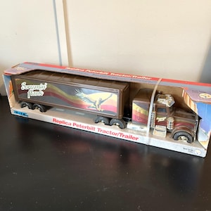 May include: A handmade wooden sign with the text "Welcome" in a playful font. The sign features a distressed finish and a simple, rustic design, perfect for a front door or entryway. The sign measures approximately 12 inches wide.