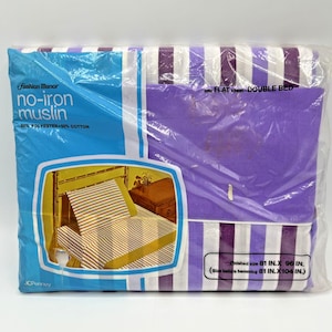 May include: A packaged flat sheet for a double bed. The sheet is purple and white striped. The packaging is a clear plastic bag with a blue and white label that reads "Fashion Manor no-iron muslin". The finished size is 81 inches by 96 inches.
