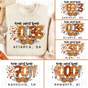 May include: Cream-colored sweatshirt with the text "Home sweet home" and a graphic of a zip code in orange and brown plaid. The zip code is 30033, with "atlanta, ga" below. Additional designs include leaves and bows.