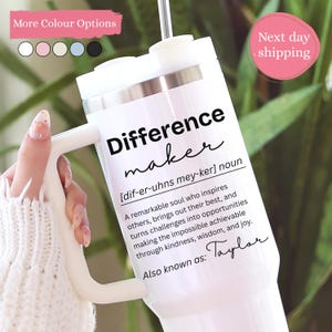 May include: A white insulated tumbler with a handle and a metal straw. The tumbler features black text that reads: Difference maker [dif-er-uhns mey-ker] noun. A remarkable soul who inspires others, brings out their best, and turns challenges into opportunities making the impossible achievable through kindness, wisdom, and joy. Also known as: Taylor.