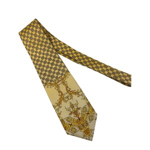 May include: A yellow necktie with a repeating geometric pattern on the top portion and a floral design on the bottom. The tie is made of a silky material and has a classic pointed end.