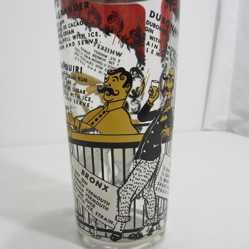 May include: A vintage glass featuring a black and white illustration of two men standing at a bar. The glass has a list of cocktail recipes printed on it, including the "Bronx", "Daiquiri", and "Dubonnet".