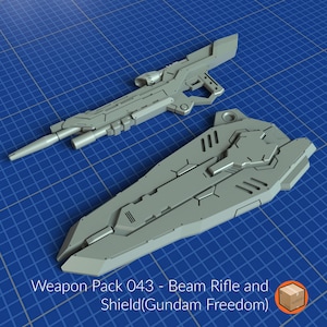 May include: A gray plastic model kit of a beam rifle and shield, part of a weapon pack for a Gundam Freedom model. The text "Weapon Pack 043 - Beam Rifle and Shield(Gundam Freedom)" is visible in the image.