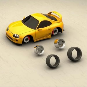 May include: A yellow sports car with detached wheels. The car has a spoiler and black windows. Four detached tires and rims are next to the car. The car's brake calipers are red.