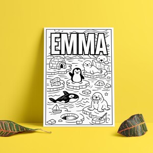 May include: Black and white illustration featuring the name "EMMA" above a scene with an igloo, penguin, orca, seals, walrus, fish, and a polar bear. The artwork is on a white background.