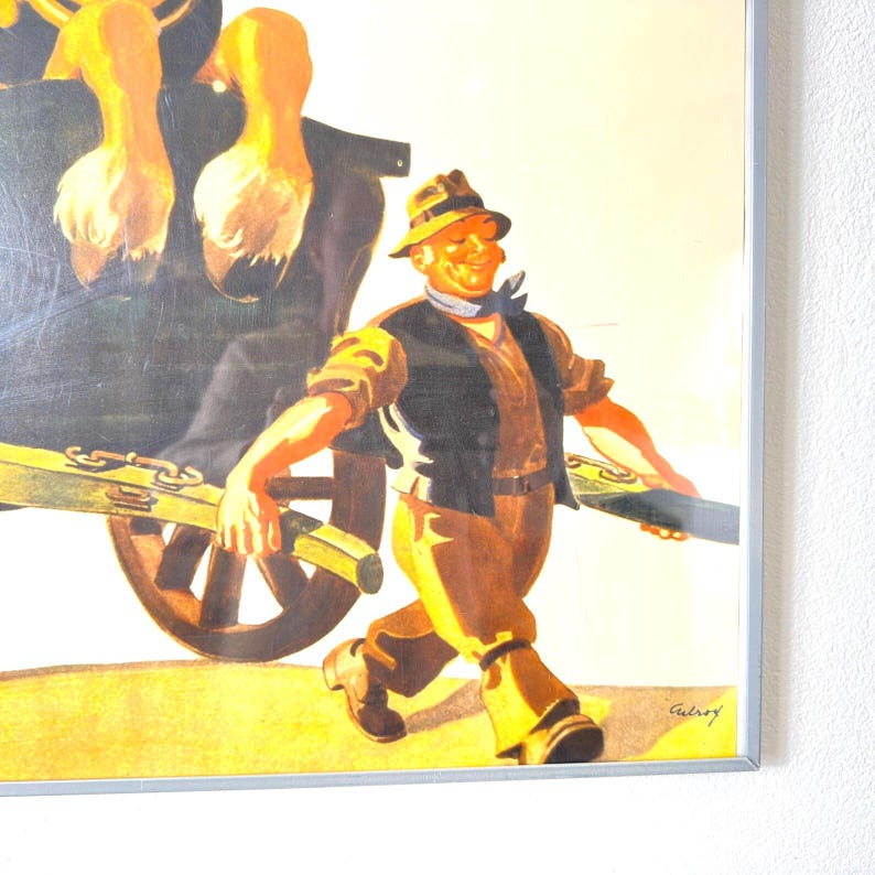 May include: Framed vintage print featuring a smiling man in a hat and vest pulling a cart with a load of what appears to be ducks. The artwork has a warm color palette with shades of yellow, brown, and black.