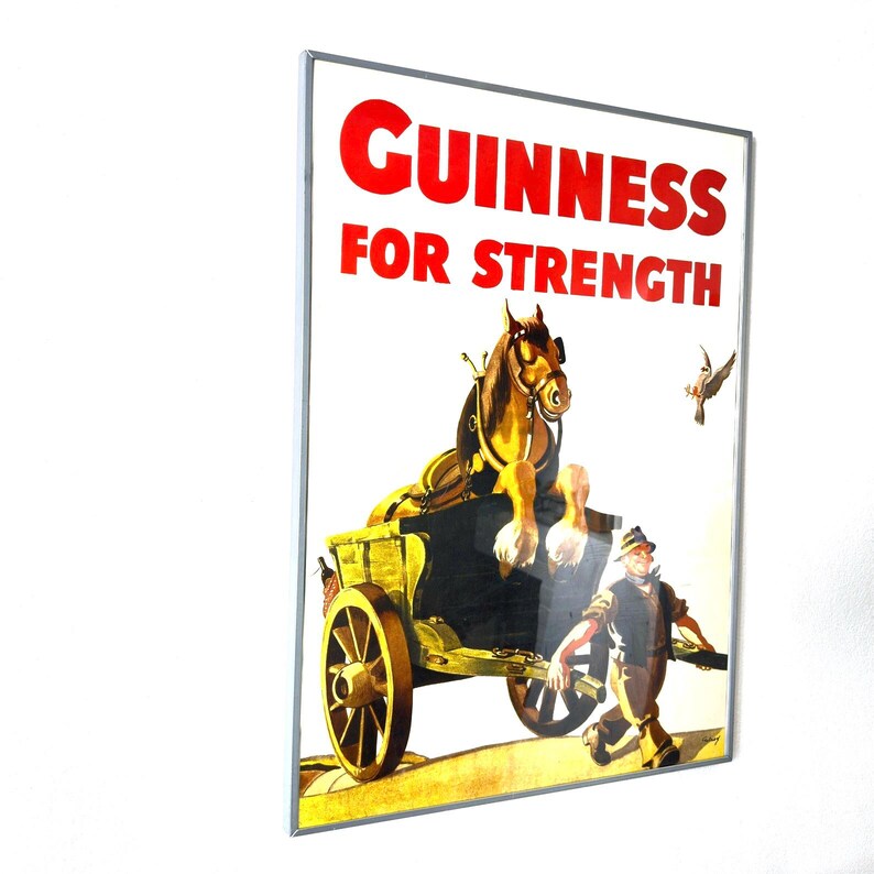 May include: Vintage Guinness advertisement poster. The poster features a brown horse pulling a yellow cart, with a man walking alongside. The text "GUINNESS FOR STRENGTH" is in red letters at the top. A bird is flying in the background.