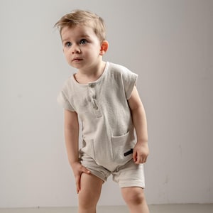 Neutral Baby Boy Romper – Short Sleeve Textured Cotton One-Piece with Pocket & Button Front | Minimalist Summer Outfit (6M–3Y)