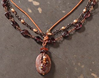 True of Heart multi strand necklace: wire wrapped matte Norena jasper pendant, garnet nuggets, pearls, leather, copper