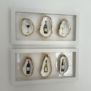 Muurkunst met oesterschelpwijn: handgeschilderd trio
