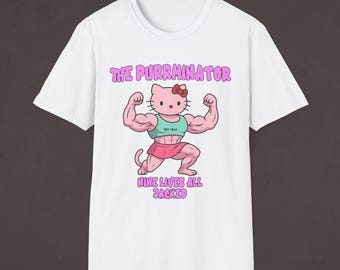 May include: White t-shirt with a pink and white cartoon image of Hello Kitty with muscles. The text "The Purrminator" and "Nine Lives All Jacked" is printed on the shirt.